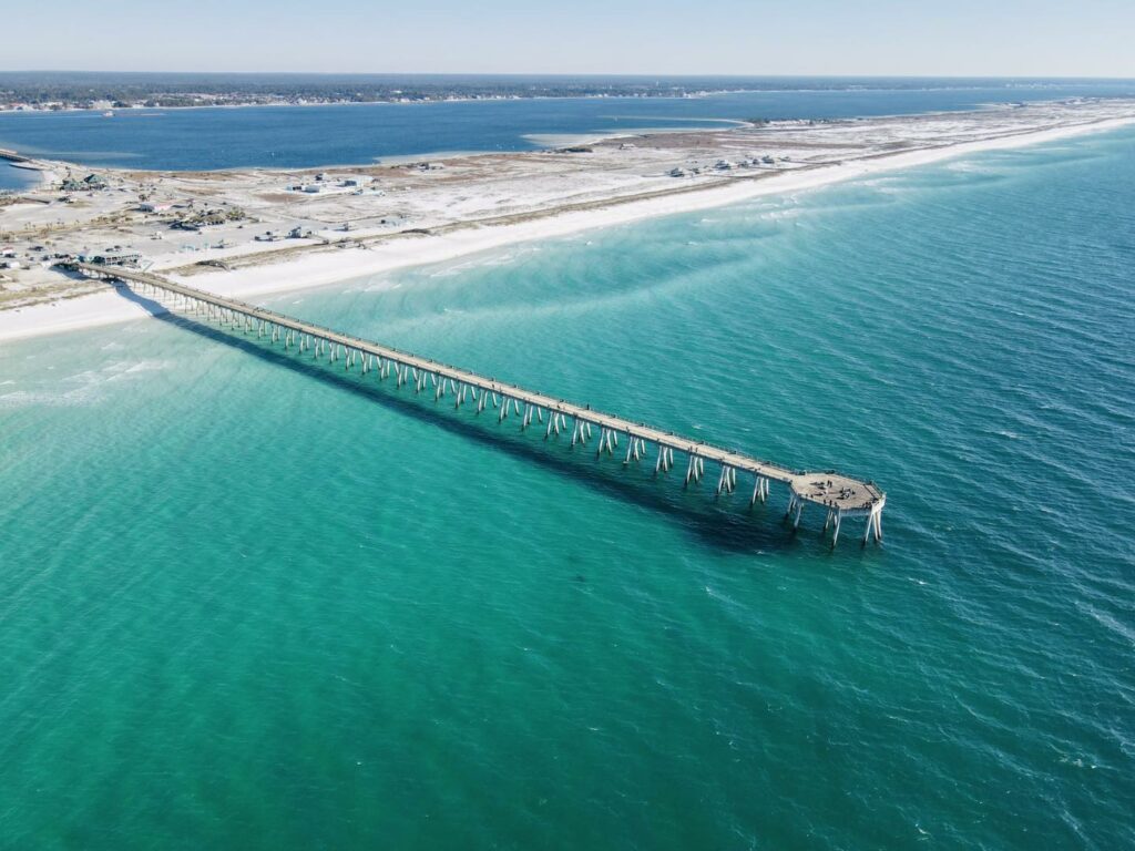The wonderful stretch of Navarre beach, leading to Navarre Beach Pier, over the crystal clear waters of the gulf of mexico