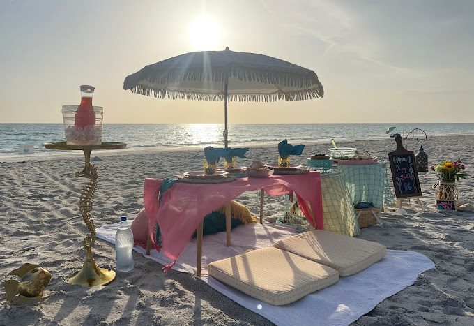 A beautiful and romantic picnic spread, offered by Sandy Toes Luxury Beach Picnics.