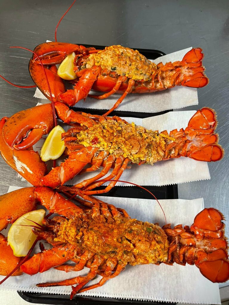 Whole stuffed lobsters, served at Maria's Fresh seafood market, ready for customers to take home and cook immediately.