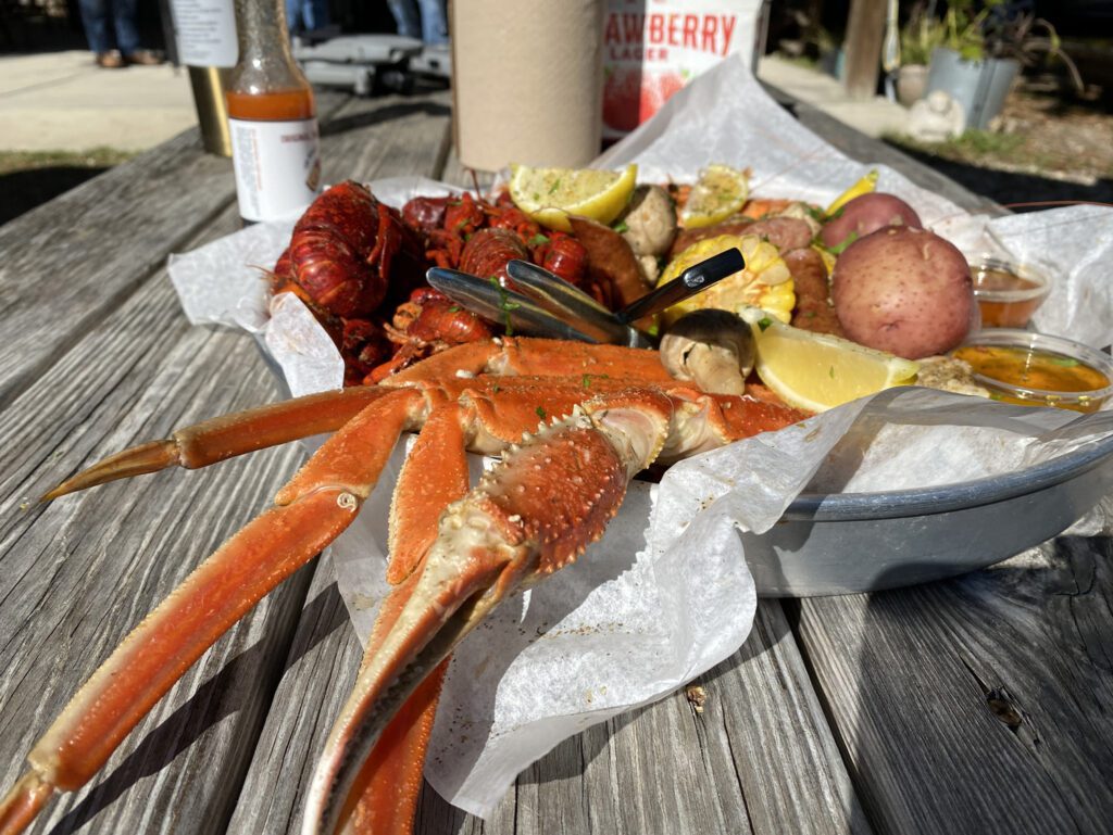 A scrumptious and mouthwatering seafood basket, with lobster tail, king crab legs, sweet potato, corn and much more at Where Y'at Seafood Restaurant